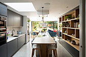 Island counter with breakfast table extension in fitted kitchen