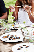 Shrimp skewers and grilled mussels with herb butter