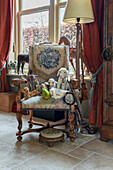 Vintage-style soft toys on antique armchair in living room decorated with flea-market finds