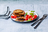 Vegetable pancakes with tomatoes and grainy cream cheese