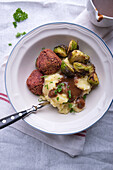 Vegan potato-celery mash with Brussels sprouts and beetroot falafel
