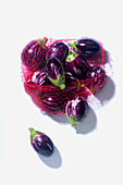 Purple and white striped aubergines in a net