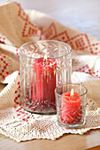Red pillar candles in crystal candle lanterns