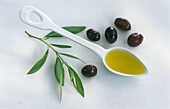 Spoon with olive oil, and fresh olives