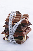 Stacks of chocolate bars with a measuring tape