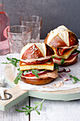 Tomato burgers in pretzel buns with grilled cheese