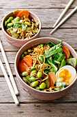 Asian soup with noodles, edamame and egg