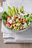 Salad bowl with avocado, croutons and parmesan cheese