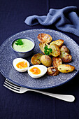Baked potatoes with green sauce and waxy egg