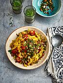 Vegan saffron couscous with chickpeas, vegetables and tomatoes