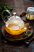 Sea buckthorn tea in a glass teapot