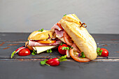 Baguette sandwich with ham, cheese and tomatoes