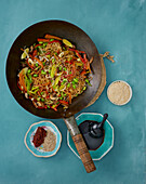 Vegan Mie noodle pan with colourful vegetables and sesame seeds