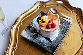 Raspberry mousse tartlet with edible flowers