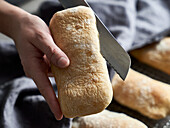 Panini bread being cut in half