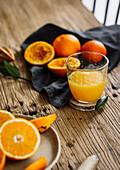 Freshly squeezed orange juice and oranges
