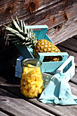 Diced Pineapple in a glass and whole pineapples in a wooden box (for fasting)