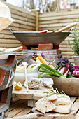Garden table with fresh herbs, vegetables and flatbread