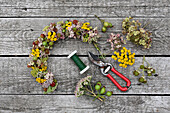 Late summer wreath on a wire ring (sedum, tansy, blackberries, rose hips, hydrangeas)