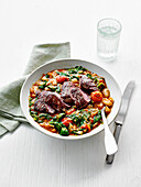Cajun lamb steaks with smoky beans and tomatoes