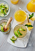 Tropical Rum Cachaca, mango-passion fruit nectar and pineapple skewers on grey wooden background