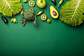 Green fruit and vegetables on green background