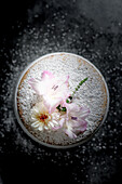 Sponge cake decorated with icing sugar, dahlia and gladioli
