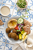 Fried falafel bowl with hummus and fresh vegetables
