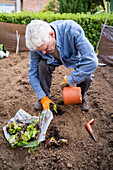 Full length of active senior man gardening at orchard