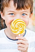 Portrait of little boy with lollipop