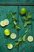Mint and limes on rustic wooden background
