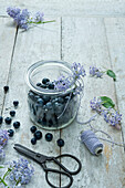 High angle view of blueberries in jar on wooden table
