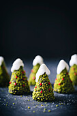 Chocolate cake, christmas tree shaped, decorated with pistachio and icing