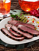 London broil beef with rice and a grilled lime