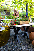 Table with planter box, balloon bottle and sculpture on the terrace