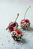 Close-up of chocolate covered cherries and quinoa on table
