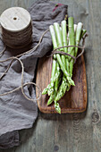 Bunch of green asparagus on wooden board