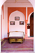 India, Rajasthan, Alwar, Heritage Hotel Ram Bihari Palace, Corridor with sofa and old table