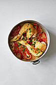 Pan roasted chicken legs with peppers, garlic and parsley