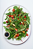 Salad made with arugula, grilled chicken and fresh strawberries