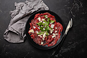 Italien beef carpaccio with parmesan cheese and arugula
