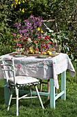 Vintage-style garden table with posies of zinnias