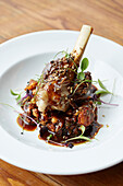 Lamb shank with coriander seeds and micro herbs