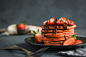 Red pancakes with strawberries