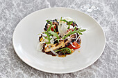Octopus, fennel, tomato and rocket salad with fried garlic