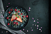 Black waffles with berries
