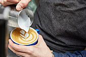 Latte art being poured on a coffee