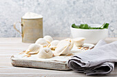Raw uncooked pelmeni - traditional Russian dumplings with minced meat filling