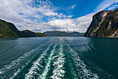 Boat's wake streaks through Geirangerfjord, Norway