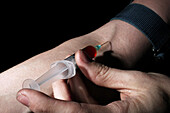 Heroin user injecting drug